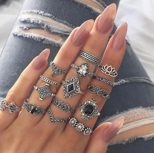 Close-up of 15-piece vintage silver bohemian midi ring set with blue gemstones and floral motifs