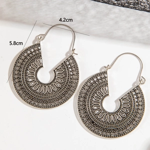 Detailed view of bohemian hollow floral pattern earrings with 5.8cm length measurements