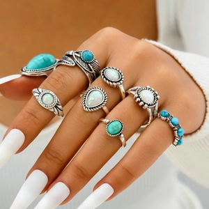 Bohemian vintage ring set with turquoise and opal stones featuring floral and leaf carvings