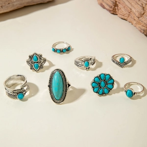 Detailed view of bohemian style turquoise rings with vintage silver feather carvings