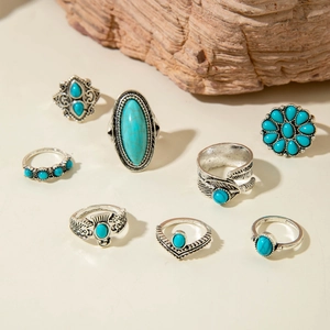 Detailed view of bohemian turquoise rings with vintage silver feather carvings and ethnic patterns