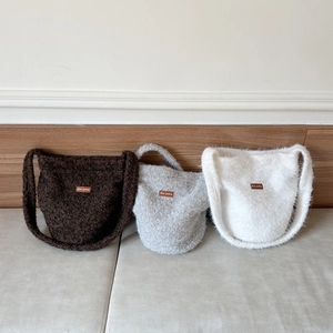 Plush tote bags in brown, grey and white with textured faux fur and leather logo patch