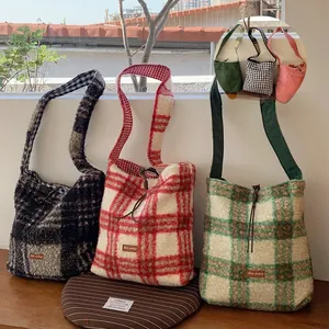 Detailed view of plaid lamb wool tote bags in black, red, and green with drawstring