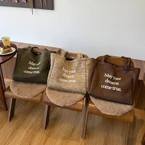 Three oversized suede tote bags with leopard print and dream quote in a cozy cafe setting