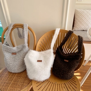 Plush bucket bag in gray white and brown with leather logo tag for autumn winter