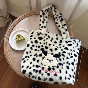 Detail of plush polka dot tote bag featuring a cute puppy embroidery and soft handles
