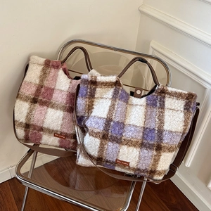 Close-up of large plaid plush tote bags featuring Star-picking tags and adjustable straps