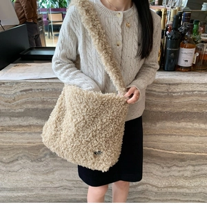 Sac fourre-tout beige en polaire pelucheuse avec texture bouclée et longue bandoulière