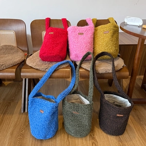 Fuzzy plush bucket bag in various colors with star picking leather label detail