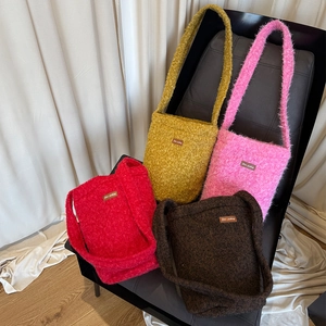 Retro plush bucket bags in multiple colors featuring fluffy shearling texture and shoulder strap