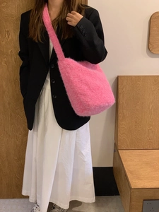 Detail of soft pink plush bucket bag made of long faux fur for autumn winter fashion