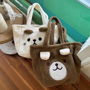 Detail view of plush lamb wool tote bags featuring cute 3D ears and cartoon embroidery