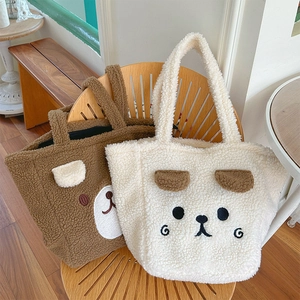 Detail of plush teddy fleece tote bags with cute 3D bear ears and soft fuzzy texture