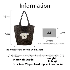 Detail of leopard print suede tote bag featuring plush puppy patch and zipper lining