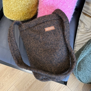 Top view of brown plush bucket bag with fuzzy texture and leather Star-picking patch