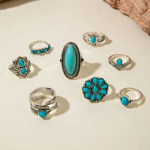 8-piece bohemian silver ring set featuring turquoise stones and feather engraving detail