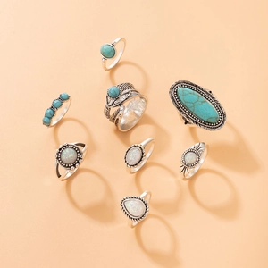 Detailed flat lay of a 7-piece vintage bohemian ring set with turquoise and opal stones