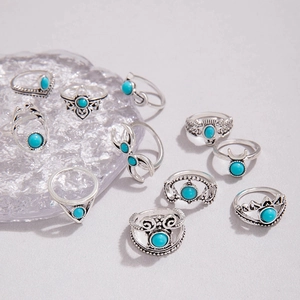 Close-up of 10-piece bohemian silver rings set with turquoise stones and ethnic engravings