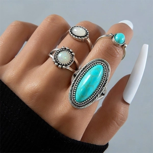 Detail of four-piece vintage bohemian rings with turquoise and opal effect stones