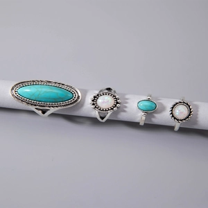 Detail view of 4-piece vintage boho ring set with turquoise and opal stones on gray background