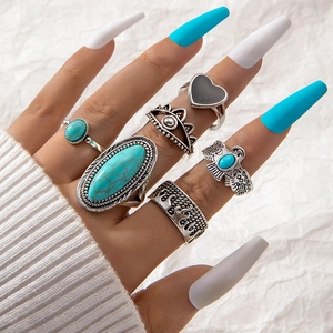 Detail of vintage bohemian silver rings with turquoise stones and eagle motifs
