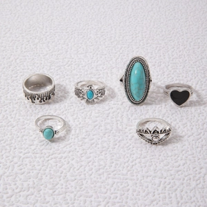 Detailed view of six vintage bohemian silver rings with turquoise and eagle motifs