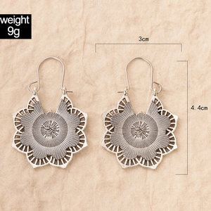 Detailed view of bohemian antique silver mandala earrings with size and weight measurements