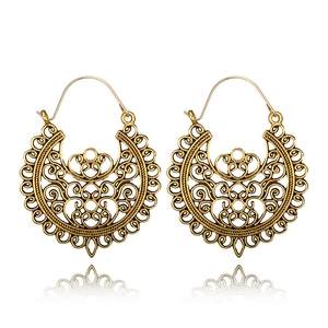 Bohemian vintage hollow floral earrings in gold metal finish on white background