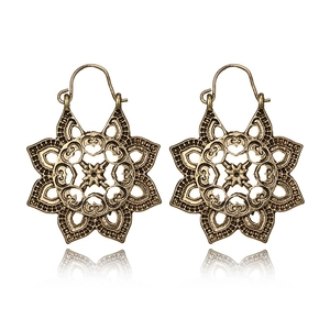 Bohemian mandala hollow carved metal earrings in vintage bronze finish on white background