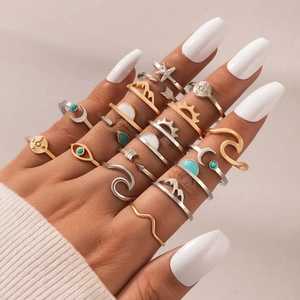 Bohemian multi-piece ring set with sun, moon, and compass motifs in gold and silver