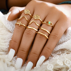 Close-up of 8pcs bohemian gold stackable rings featuring sun and evil eye charms
