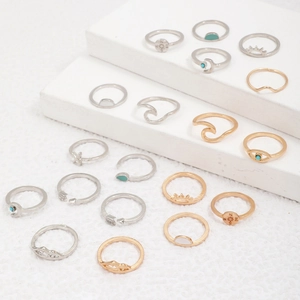 Detail of 18-piece bohemian ring set with moon sun and evil eye symbols in gold and silver