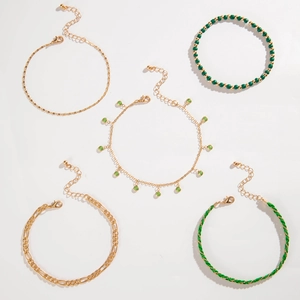 Detail of 5-piece bohemian layered anklet set with green beads and gold-tone chains