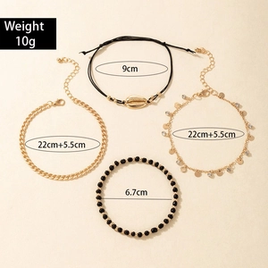 Detail view of 4-piece beach anklet set with golden chains, shell pendant and woven cord
