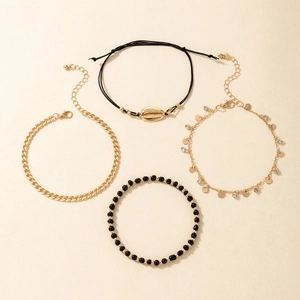 Detail view of 4-piece beach anklet set featuring shell charms and gold-tone chains