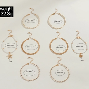 Detail of 8pcs set gold bead anklets with shell and starfish charms, sizing info included