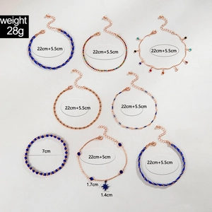Detail view of 8-piece beach anklet set featuring blue beads and alloy star charms