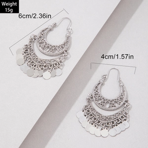 Detail view of silver boho crescent earrings with dimensions 6cm and metal sequins
