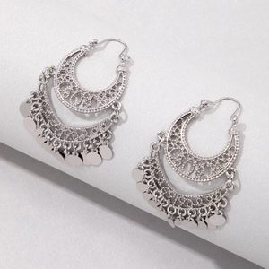 Detailed view of silver bohemian U-shaped tassel earrings with ethnic filigree design