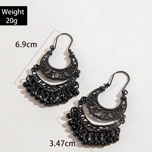 Detailed view of black U-shaped tassel earrings with bohemian hollow patterns and dimensions
