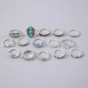 Detailed close-up of a 15-piece vintage bohemian silver ring set with turquoise stones
