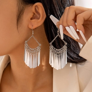 Detail of bohemian silver tassel earrings with hollow crescent moon and retro fringe