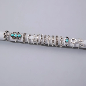 Detail of 13-piece vintage silver alloy knuckle rings with turquoise stones and floral moon stars
