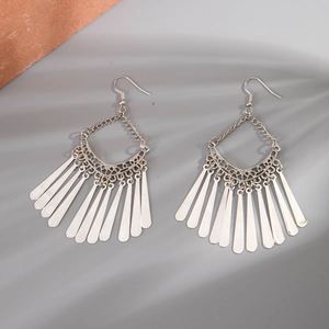Detailed view of bohemian silver tassel earrings with geometric hollow moon patterns