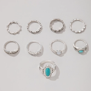 Detail view of a 9-piece vintage silver alloy ring set featuring turquoise and floral designs