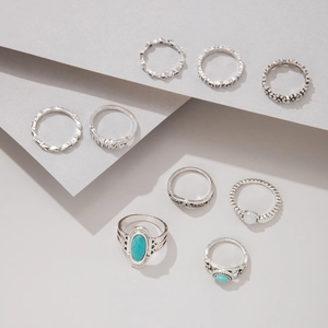 Detailed close-up of 9-piece bohemian silver rings with turquoise and floral relief motifs