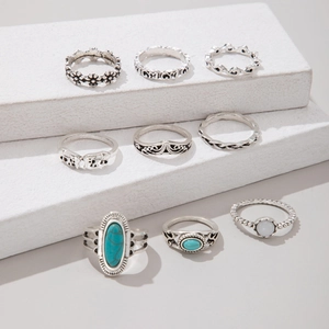Macro shot of 9-piece vintage silver rings with turquoise motifs on geometric props