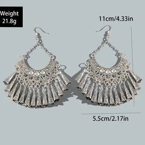 Detail view of vintage bohemian earrings with silver tassels and white crystal studs
