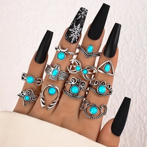 Detailed view of 11pcs vintage bohemian silver rings with turquoise stones worn by model