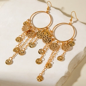 Detail of gold hollow U-shaped earrings with long tassel chains and hammered metal discs